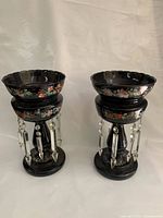 Both black glass lusters with prisms visible