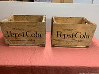 Both Pepsi-Cola crates front view showing logos