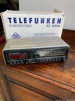 Clock radio with box on wooden surface