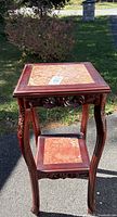 Full view of rosewood side table showing both tiers and carved details
