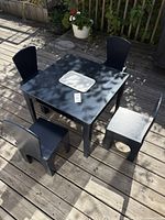 Top view of table with four chairs on deck