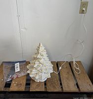 Full view of ceramic tree with power cord and bag of spare pegs