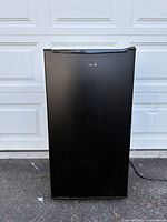 Front view of black mini fridge