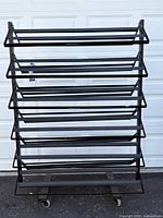 Full front view of rack showing 12 angled shelves and casters