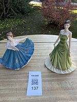 Both figurines on table with lot number 137