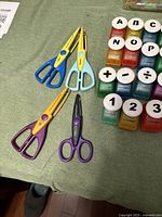 Four decorative scissors and grid of alphabet and symbol punches