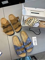 Top view of three pairs of sandals on table