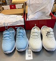 Two pairs of Propet knit walking shoes light blue and white in boxes