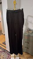 Black wide-leg pants hanging front view