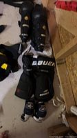 Bauer hockey pants, elbow pads and Reebok shin guards laid out