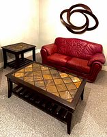 Coffee table, side table, loveseat, wall decor visible