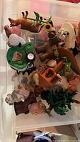 Overview of top layer showing farm animals, plastic lawnmower, tree and play structure pieces