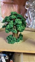 front view of green resin musical tree figurine