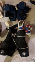 Entire lot showing pants, gloves, neck guard, shoulder pads