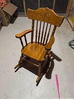 Front angled view of oak children's rocking chair