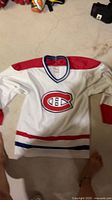 Full view of Montreal Canadiens CCM jersey lying flat