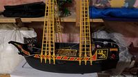 Starboard side view of Playmobil pirate ship showing hull decals and masts