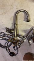 Kitchen faucet, hoses, secondary faucet component visible