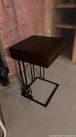 End table front angle showing drawer, metal base, power cord