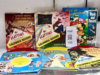 All six record sleeves and colored vinyl discs displayed