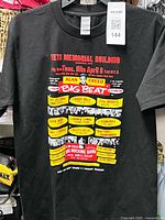 Full view of black Alan Freed Big Beat concert poster T-shirt on hanger