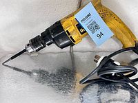 Left side view showing full drill, chuck, bit, and cord