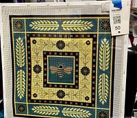 Front view of framed needlepoint canvas showing complete design and dimensions