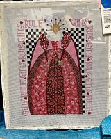 Front view of framed needlepoint showing full design and frame