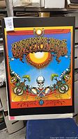 Full view of unframed Grateful Dead Aoxomoxoa poster leaning against shelf