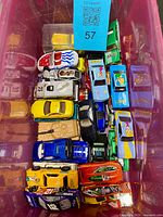 Top view of assorted loose die-cast cars inside tote