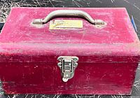 Closed red toolbox front view with latch