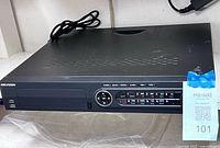 Front angled view of Hikvision DVR showing control keypad, USB ports, no HDD bay cover