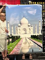 Front view showing full Taj Mahal poster held by person for scale