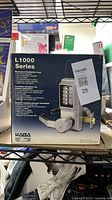 Front of sealed retail box showing L1000 Series mechanical pushbutton lock