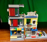Front view of assembled two-section LEGO city modular building on wooden surface