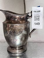 Front view of silverplate water pitcher showing overall form and tarnish