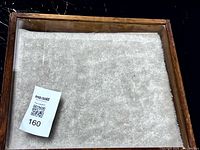 Top view of closed case showing wood frame and glass pane