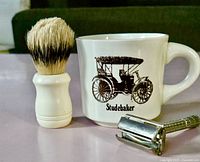 Full view of shaving brush, Studebaker mug, Gillette razor