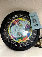 Front view of world time clock showing map and time scale