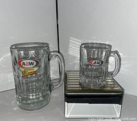 Full view of both glass mugs: one standard size, one mini