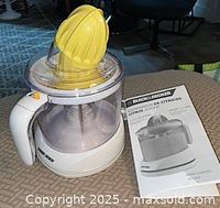 Juicer assembled with cone, manual beside