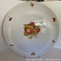 Front view of 13 in white ironstone platter with fruit design and swirl texture