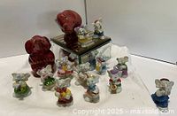 Group shot of all elephant figurines including band and larger circus pair