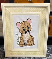 Front view of framed cub crewel embroidery