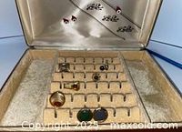 Valet box open showing satin lid décor and cufflink tray with assorted single cufflinks