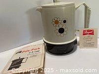 Percolator with manual and brochure displayed