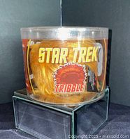 Front view showing Star Trek Tribble logo and plush inside cylinder