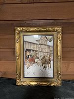 Front view of framed painting depicting horse-drawn stagecoach scene