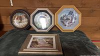 Group shot of three framed plates and one framed print