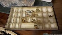 Jewellery tray with assorted rings, brooches and earrings